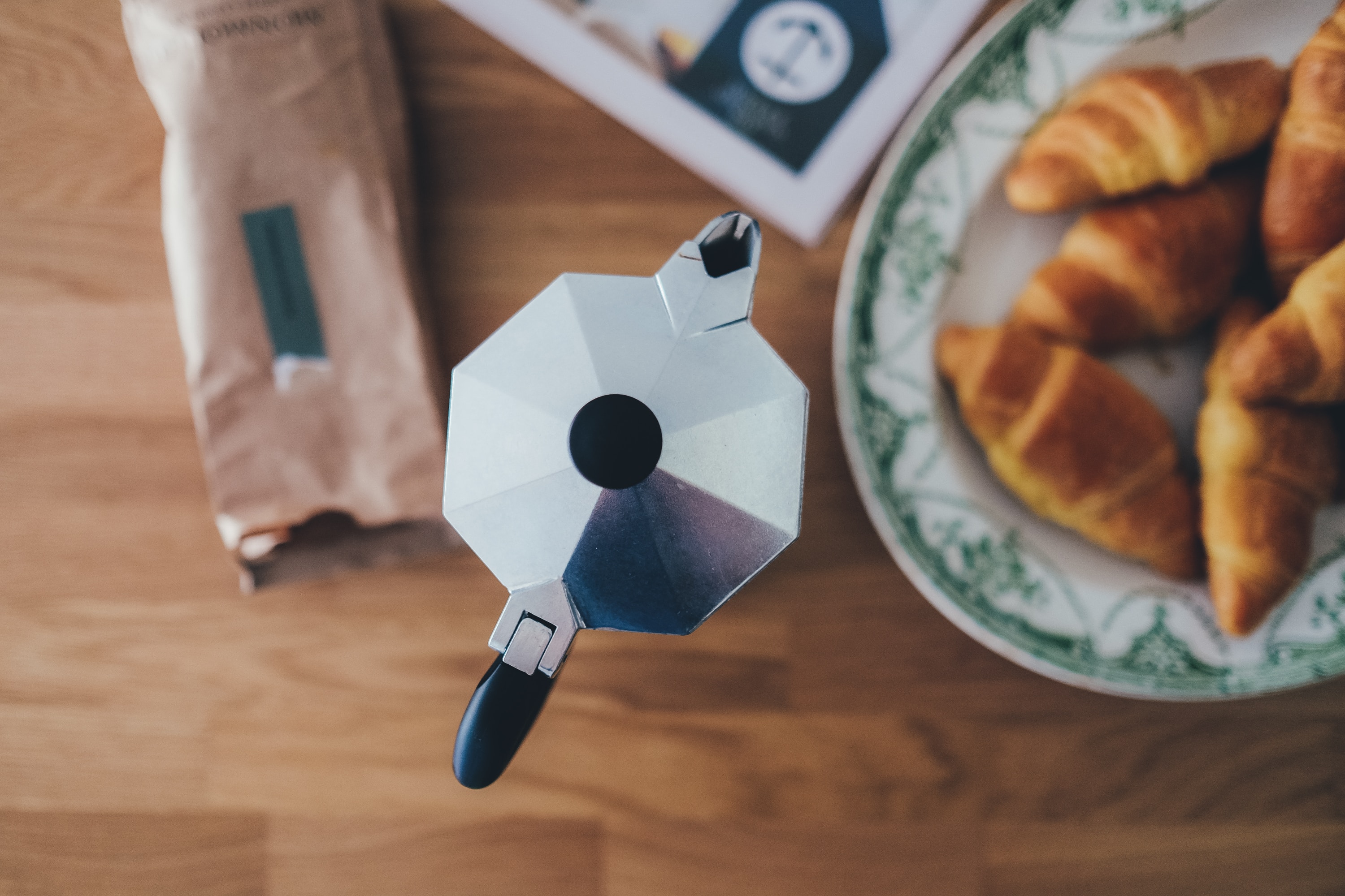 plate of croissants and a coffee pot